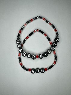 HHN Season is here!! These spooky bracelets are the perfect accessory for nights full of fear at Halloween Horror Nights. Black Themed Bracelet For Halloween, Halloween Themed Black Bracelet, Black Halloween Themed Bracelet, Novelty Black Beaded Bracelets For Halloween, Handmade Halloween Festival Bracelets, Handmade Halloween Festival Bracelet, Handmade Rave Jewelry For Halloween, Gothic Adjustable Beaded Bracelets For Halloween, Adjustable Red Beaded Bracelets For Halloween