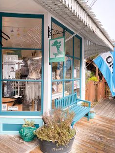 a blue bench sitting in front of a store