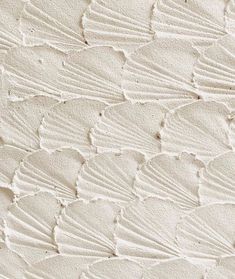 an image of white sand textured with waves and lines on it's surface