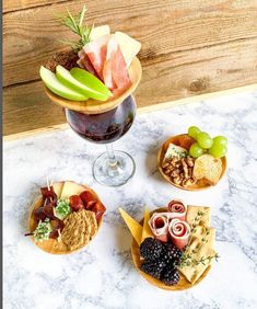 an assortment of cheeses, crackers and meats on a table