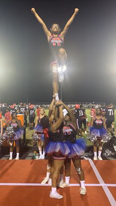 the cheerleaders are doing tricks for the crowd