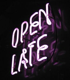 a neon sign that says open late at night