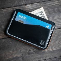 Hello, for sale is minimalistic leather card holder made of top quality leather Shell Cordovan Horween USA. Leather varies ±1.5-1,8mm / 4-4.5oz thickness. Slim and compact card holder for your cards and paper money. Check colors here: https://www.etsy.com/listing/842671392/leather-colors-for-my-listings The cardholder measurements are 10.5x7cm / 4.13x2.75in or 10.5x8cm / 4.13x3.15in (in this variation you can hold US dollar bills folded once in middle slot) PLEASE LEAVE A NOT WHICH SIZE YOU WOUL Black Minimalist Card Holder With Coin Pocket, Black Bifold Card Holder For Everyday Carry, Black Minimalist Card Holder With Card Slots, Minimalist Black Card Holder With Card Slots, Minimalist Black Card Holder With Slots, Minimalist Black Card Holder, Minimalist Black Leather Card Holder, Black Wallets With Card Slots For Everyday Carry, Black Wallets With Card Slots For Everyday