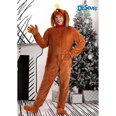 a man in a turkey costume standing next to a christmas tree with his hands out