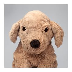 a close up of a stuffed dog on a gray background with the head turned to the side