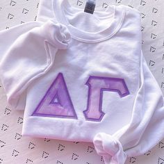 This trendy, unique, handcrafted Pink & Purple Cloud Gildan Greek Letter Crewneck Sweatshirt is sure to stand out on any campus! Grab one for you, your big/little, or a group of sisters (bulk discount information can be found below). If you need some greek letter sweatshirt inspiration, please visit the inspiration page! Picture Details Pictures: ⭑ #1-4: White sweatshirt, Light Purple background fabric Care Instructions ⭑ Wash inside out on cold & air dry for best results ⭑ Do not dry cl Cotton Campus Top With Letter Embroidery, Cotton Tops With Letter Embroidery For Campus, Customizable White School Spirit Sweatshirt, Customizable White Sweatshirt With School Spirit, Customizable White Sweatshirt For School Spirit, Collegiate White Tops With Custom Embroidery, White Custom Embroidery Sweatshirt For School Spirit, White Collegiate Top With Custom Embroidery, White School Spirit Sweatshirt With Letter Embroidery