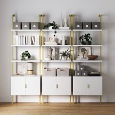 a white bookcase filled with lots of books next to a wall mounted planter