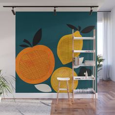 an orange wall mural in a living room with wooden flooring and white walls, along with a ladder to the right