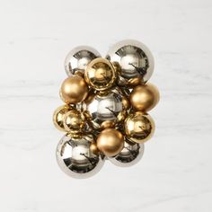 a bunch of metallic balls sitting on top of a white countertop next to each other