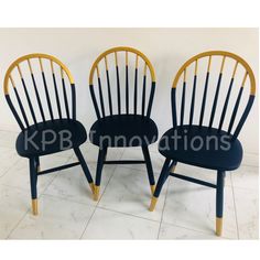 two black chairs with yellow legs and one has a blue seat pad on the back