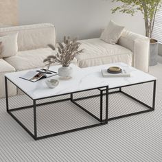 a white coffee table sitting on top of a living room floor next to a couch