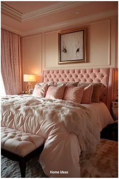 a bedroom with pink walls and white bedding in the center is a large painting on the wall