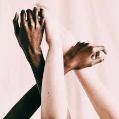 two hands reaching up to each other