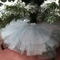 a white tutu skirt sitting on top of a christmas tree