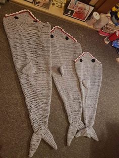 two knitted fish bodies laying on the floor