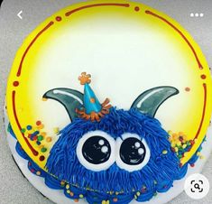 a birthday cake with a blue monster face on it