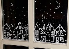 the window is decorated with black and white drawings on it's glass, which shows cityscape at night