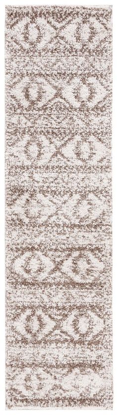 a white and brown rug with an abstract design on the bottom, it is very soft