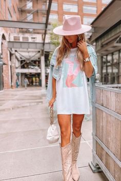 Looking for a cute country concert outfit for summer?  Try this oversized graphic tee as a dress with cowboy boots and a pink hat!  This trendy western graphic tee is the perfect addition to any outdoor country concert outfit, Nashville vacation outfit, Nashville bachelorette outfit or girly country outfit!  Shop cute western graphic tees today at Sassy Queen, your one stop shop for trendy summer outfits and cute southern summer outfits for women! Country Music Outfits, Western Summer Outfits, Summer Country Concert Outfit, Nashville Vacation, Southern Summer, Nashville Outfit, Cowgirl Boots Outfit, Country Outfit, Concert Outfit Summer