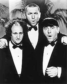 three men in tuxedos posing for the camera