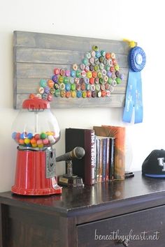 a gumball machine sitting on top of a wooden dresser