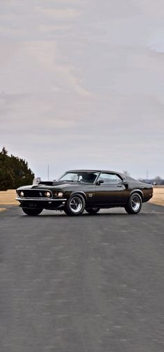 an old muscle car is parked on the pavement