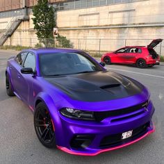 a purple and black car is parked on the street