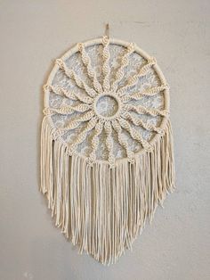 a macrame hanging on the wall with tassels