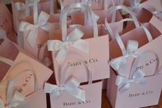 small pink boxes with white bows and names on them