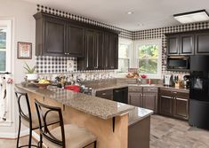 a kitchen with black and white checkered wallpaper on the walls, brown cabinets and counter tops