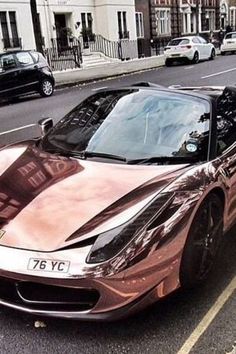 a metallic sports car parked on the side of the road