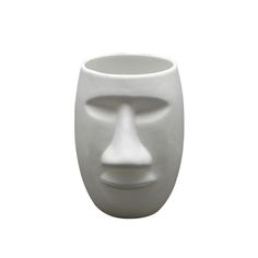 a white vase with a face on it