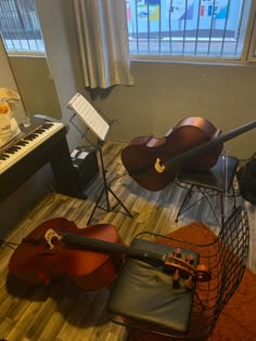 musical instruments sit on the floor in front of a piano