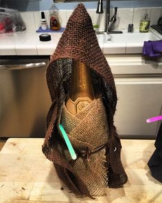 a wine bottle wrapped in burlock with a toothbrush inside it on top of a counter