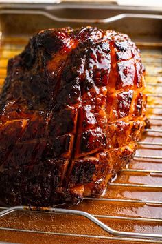 a large piece of meat sitting on top of a grill