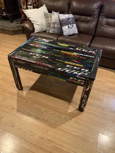 a coffee table made out of magazines on top of a hard wood floor in a living room