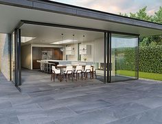 an open living room and dining area with sliding glass doors on the side of it