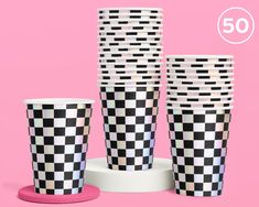 four black and white checkered cups on a pink background with the number 50 in the middle