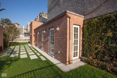 a brick building with green grass in the yard