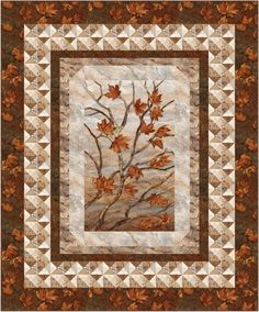 a quilted wall hanging with leaves on it