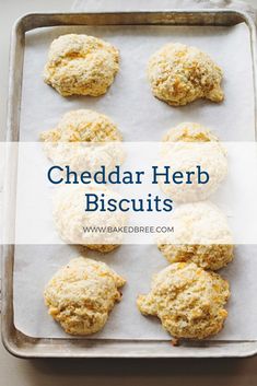 cheddar herb biscuits on a baking sheet with the words cheddar herb biscuits