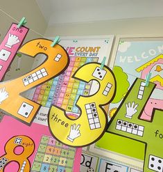 the number twenty eight is displayed in front of several colorful bulletin boards with numbers on them