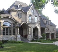 a large house with lots of windows in the front yard