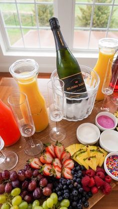 a wooden table topped with lots of different types of food and drinks on top of it