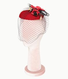 Step back in time with an enchanting accessory that adds a touch of classic elegance to any outfit! This charming 1950s fascinator hat from Unique Vintage, features delightful red flowers adorned with gold leaves perched atop, perfectly complemented by its delicate mesh veil. Whether you're attending a garden party or simply want to elevate your everyday style, this fascinator is sure to turn heads and spark conversations..Available while supplies last. | Unique Vintage 1950S Black & Red Floral Fascinator Hat Floral Fascinators, Fascinator Hats, Red Floral, Classic Elegance, Vintage 1950s, Garden Party, Red Flowers, Unique Vintage, Fascinator