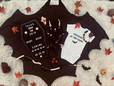 a baby's bodysuit and other items are laid out on a blanket