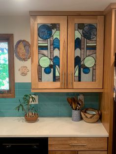 a kitchen with wooden cabinets and blue tile backsplashing, potted plants in front of the window