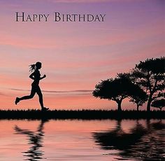 a woman running across a body of water at sunset with the words happy birthday written on it