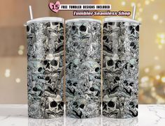 the tumbler is decorated with skulls and flowers