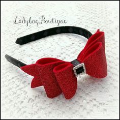 a close up of a red bow on a headband